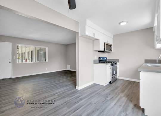 A spacious kitchen and living room with a view of the beach.