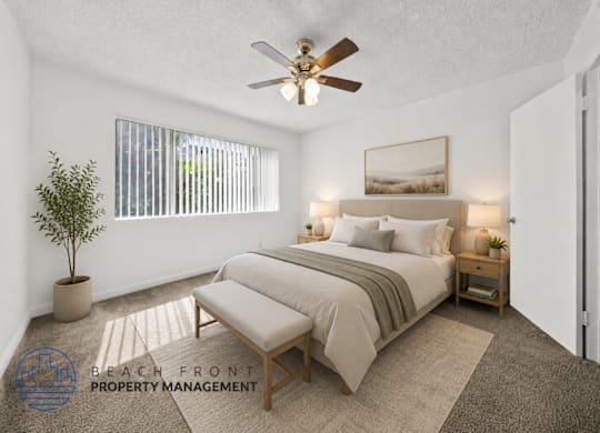 A bedroom with a bed, a bench, and a ceiling fan.