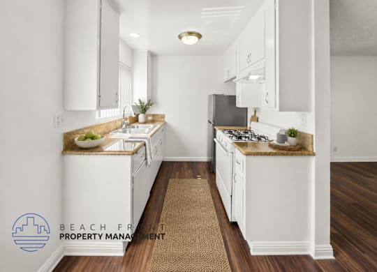 A kitchen with white cabinets and a brown rug on the floor.