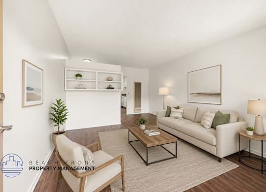 A living room with a white couch, a chair, a coffee table, and a plant.