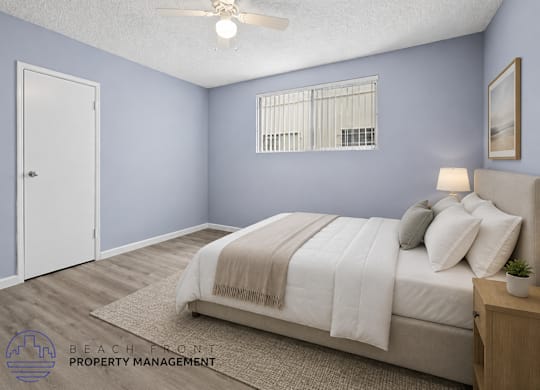 A bedroom with a bed, pillows, a ceiling fan, and a window with blinds.