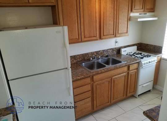 a kitchen with white appliances and wooden cabinets