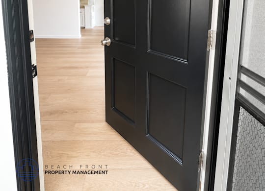 A black door with a letter K on it.