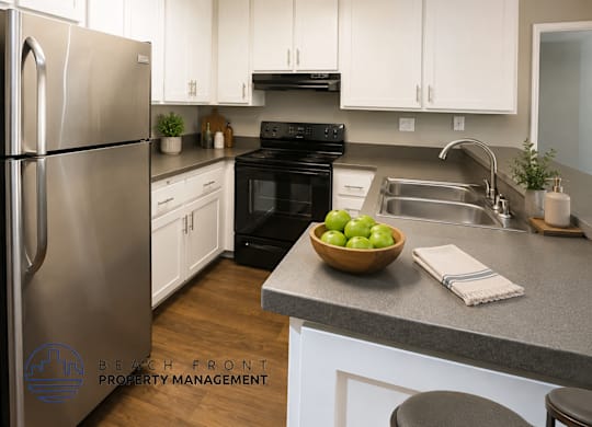 A kitchen with a refrigerator, oven, and sink.