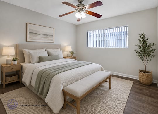 A bedroom with a bed, a bench, a ceiling fan, and a potted plant.
