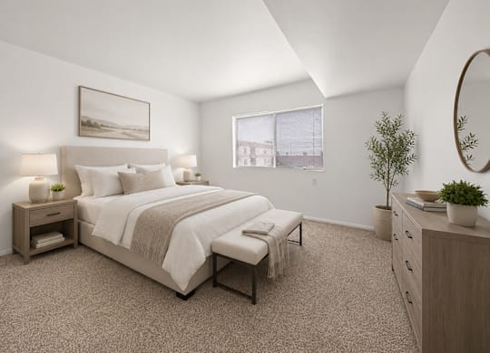 A bedroom with a large bed, nightstands, and a plant.
