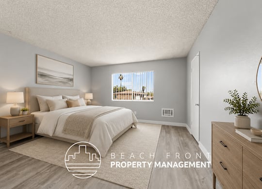 A bedroom with a large bed and a view of the beach through the window.