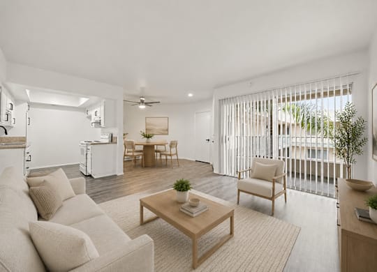 A living room with a white couch and a wooden coffee table.
