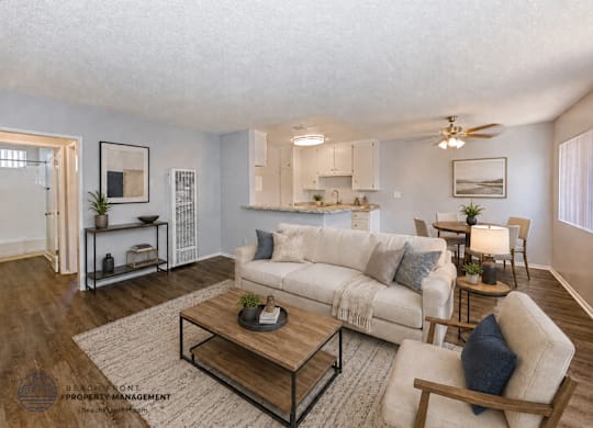 A living room with a white couch and a coffee table.