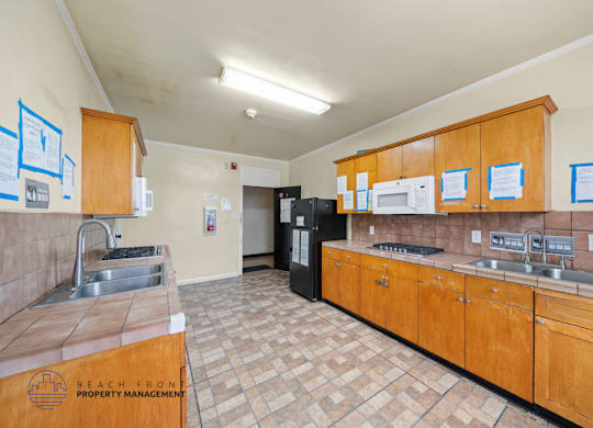A kitchen with wooden cabinets and a tile floor.