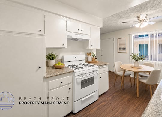 A kitchen with white appliances and wooden floors.