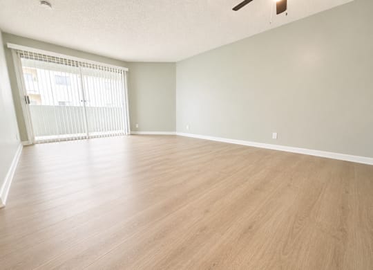 Empty room with wooden floor and white walls.