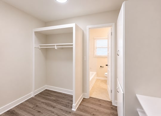 A small bedroom with a bunk bed and a doorway leading to another room.
