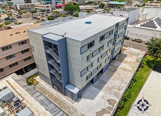 A modern building with a blue roof and a staircase on the side.