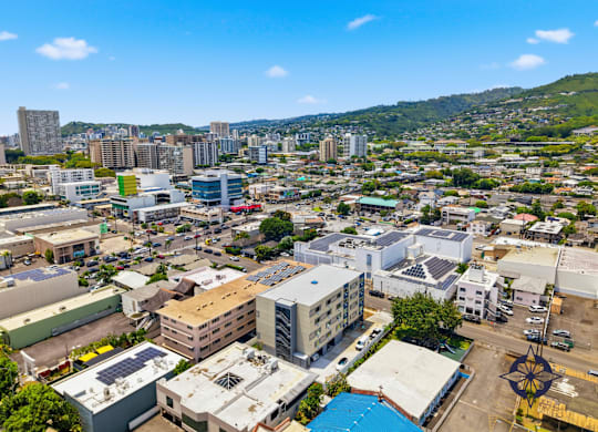 A cityscape with buildings of various sizes and a clear blue sky above.