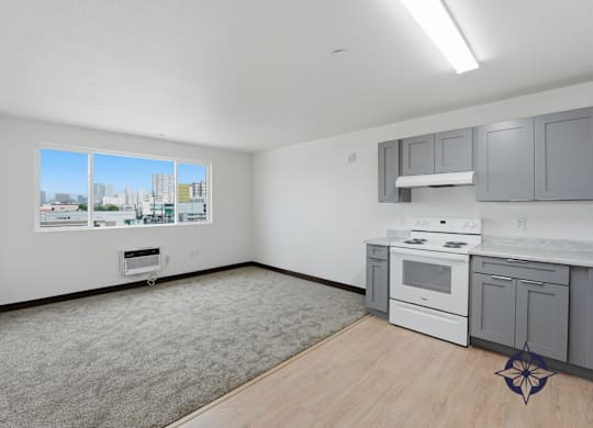 A kitchen with white appliances and grey cabinets.