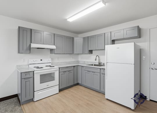 A kitchen with white appliances and grey cabinets.