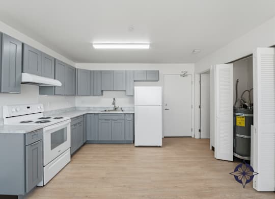 A kitchen with white appliances and grey cabinets.