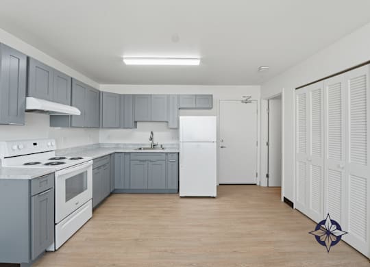 A kitchen with a white stove top oven and a white refrigerator.