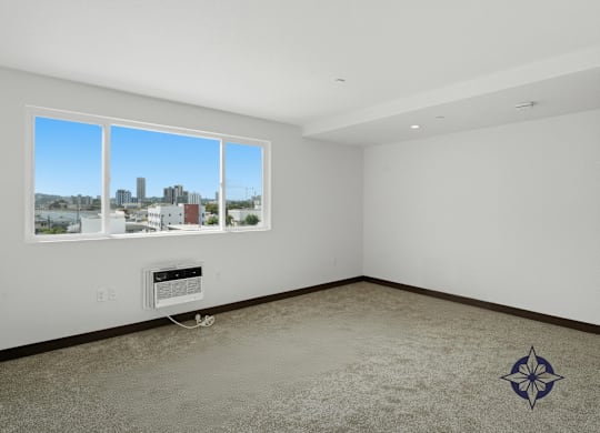 A room with a large window overlooking a cityscape.