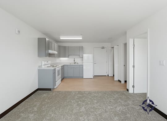 A kitchen with white cabinets and a grey floor.