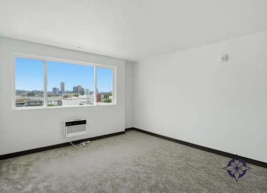 A room with a large window overlooking a cityscape.