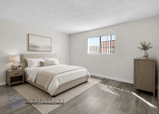 A well-lit bedroom with a large bed and a wooden nightstand.