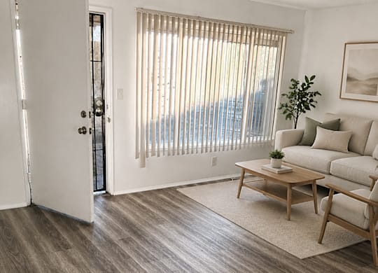 A living room with a couch, coffee table, and sliding glass doors.