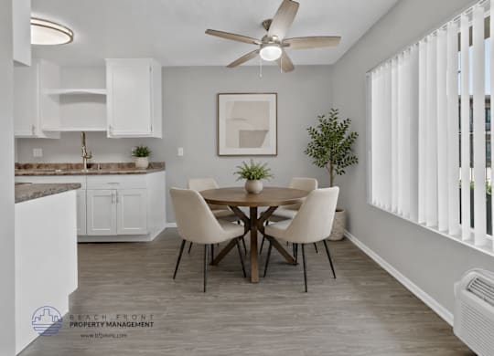 A dining room with a table set for four.