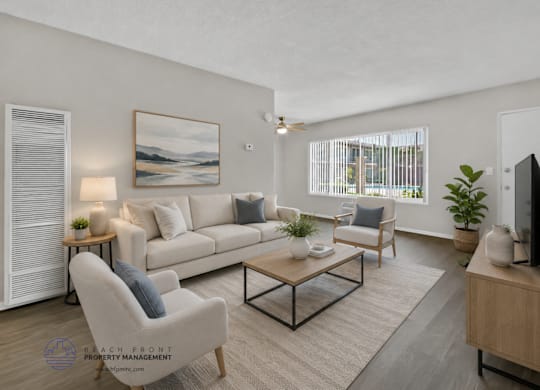 A well-lit living room with a large painting on the wall and a comfortable seating area.