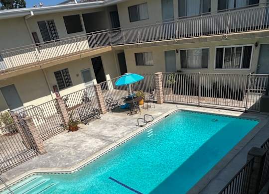 A small pool with a fence around it.