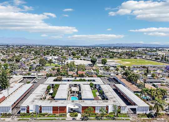 A large industrial complex with multiple buildings and a parking lot in the foreground.