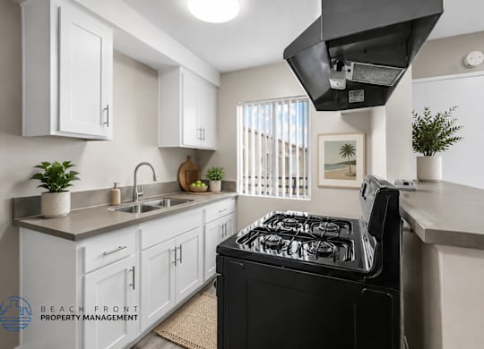 A modern kitchen with a black stove top oven.