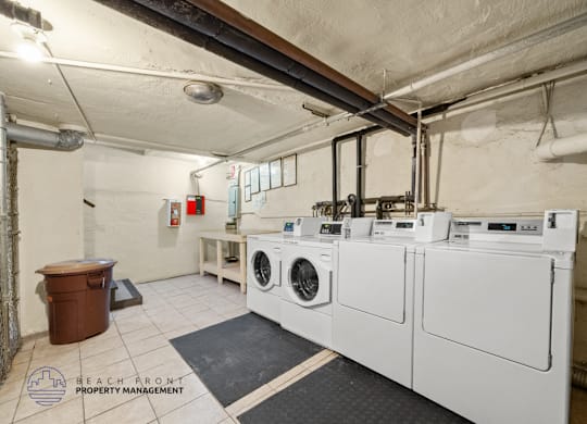 A laundry room with washers and dryers.