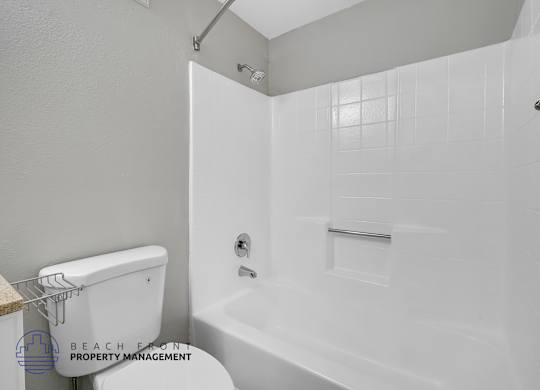 A white bathroom with a walk-in shower and a toilet.