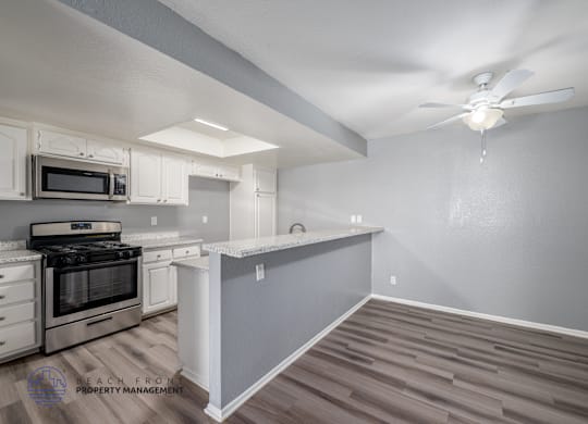 A kitchen with a stove top oven and a microwave.