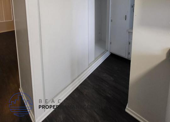 a white wall with a sliding door in a room