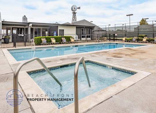 A pool with a slide and a logo for Beach Front Property Management.