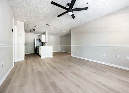 A room with a ceiling fan and light fixture.