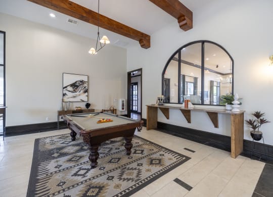 a game room with a pool table and a bar