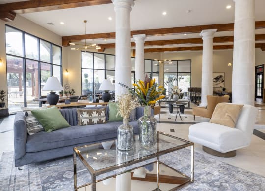 a living room with a blue couch and a glass coffee table