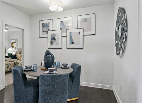 A dining room with a table set for four.