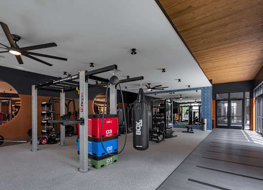 a home gym with a red and blue machine in the middle of the room