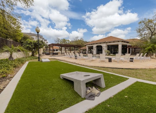 a patio with chairs and a fire pit