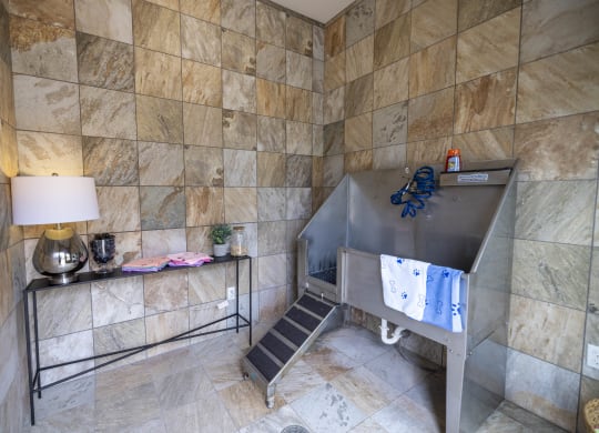 a large stainless steel tub in a bathroom with a sink