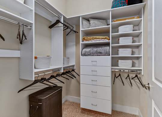 A white closet with drawers and shelves.