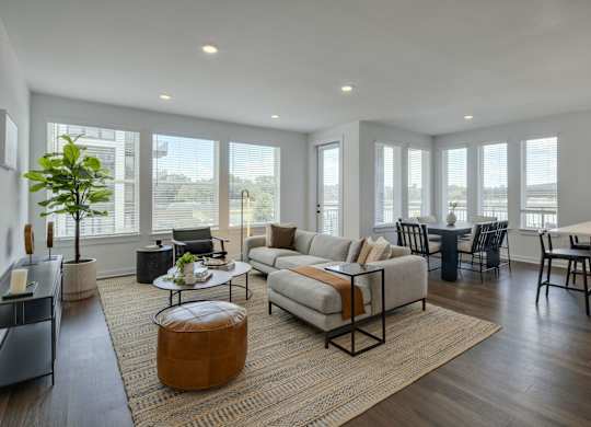 a living room with a couch and a table in front of a window