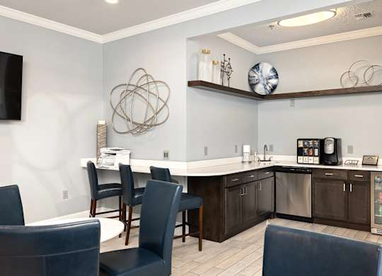A modern kitchen with dark wood cabinets and a white island.