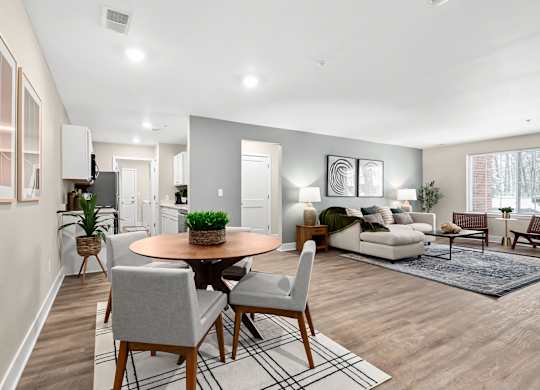 an open living room and dining room with a table and chairs