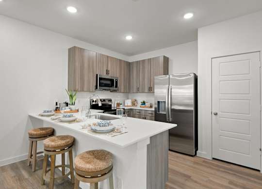 A kitchen with a white countertop and stainless steel appliances.